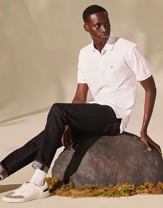 man wearing polo shirt sitting